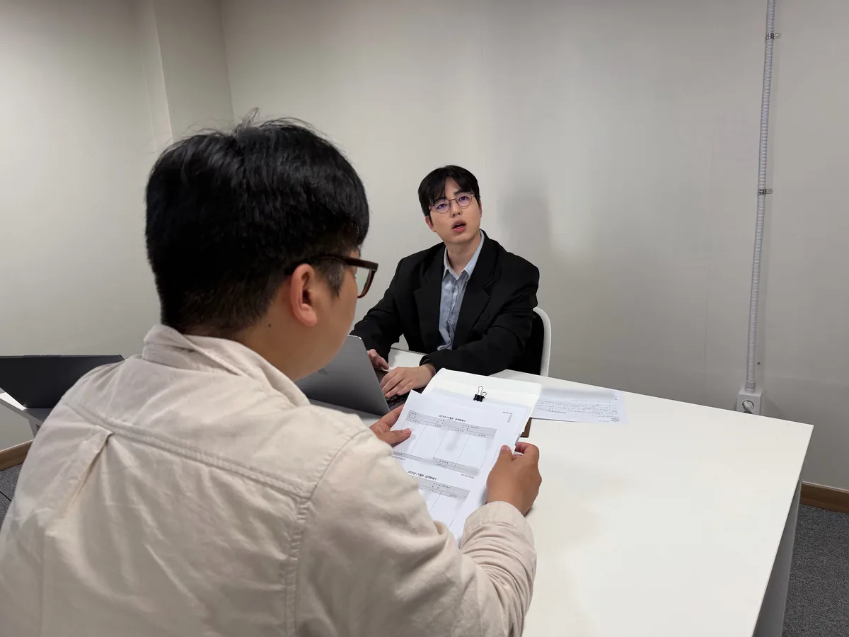 케이비자 상담실에서 담당자가 고객과 비자 서류를 상담하는 모습(고객 얼굴은 가렸어요)